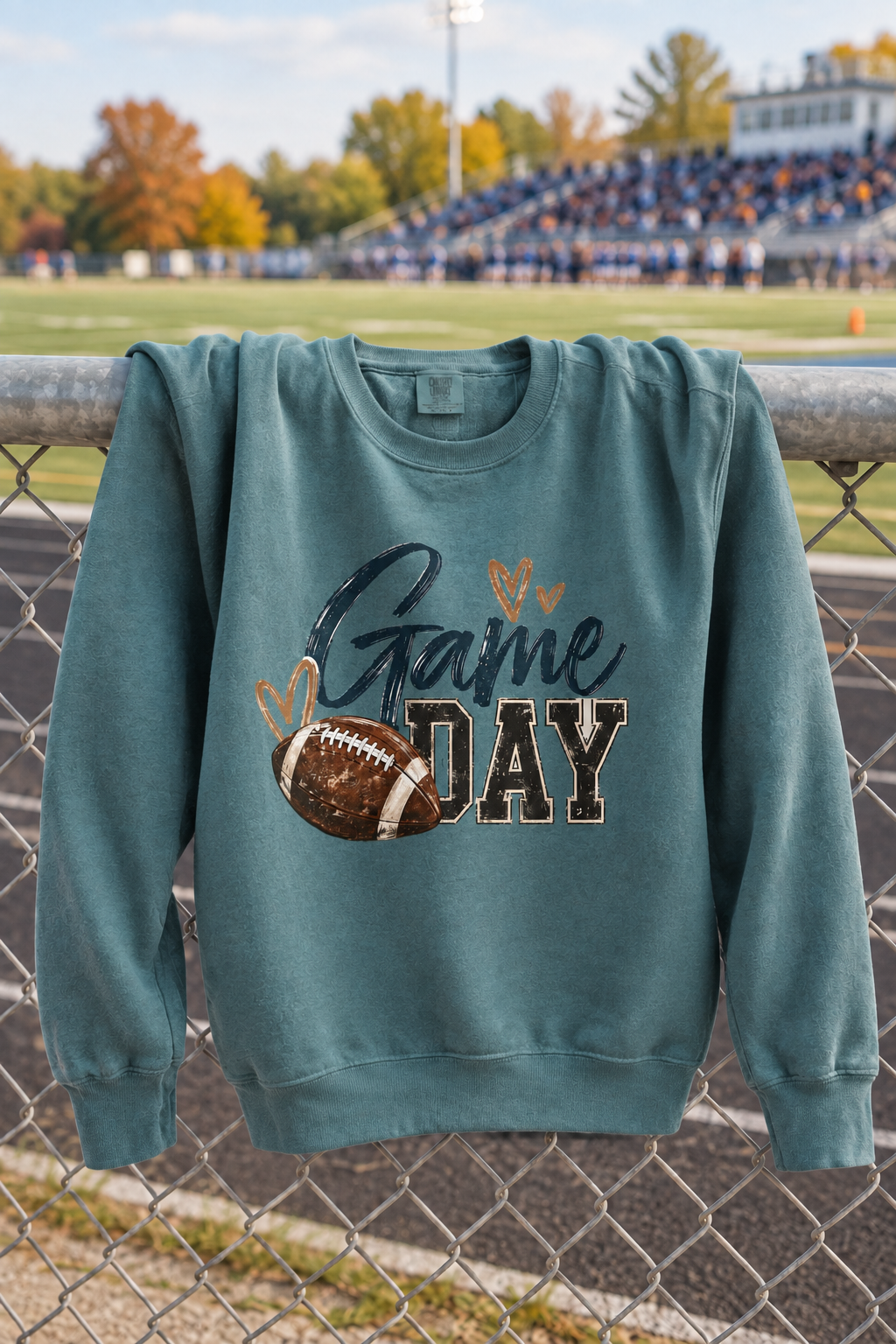 Game Day crewneck with more of its upper half draped over the fence