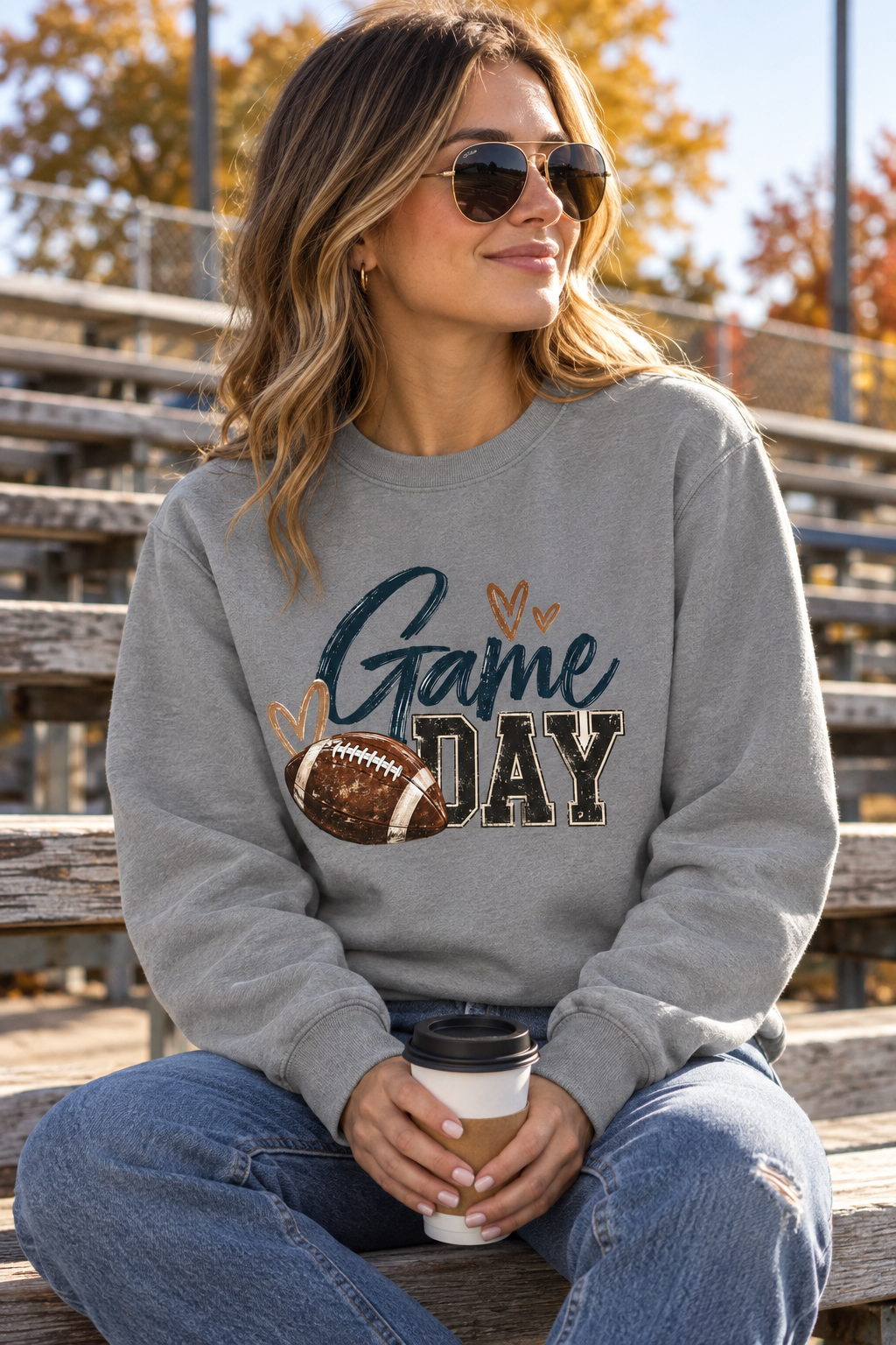 Grey Game Day crewneck on outdoor bleachers